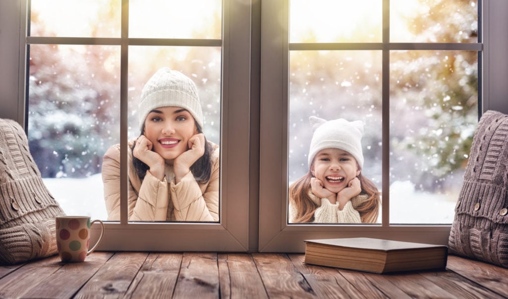 This is a woman and her daughter enjoying the winter season outside.