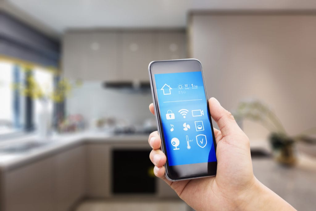 Mobile phone with apps on smart home in modern bathroom.