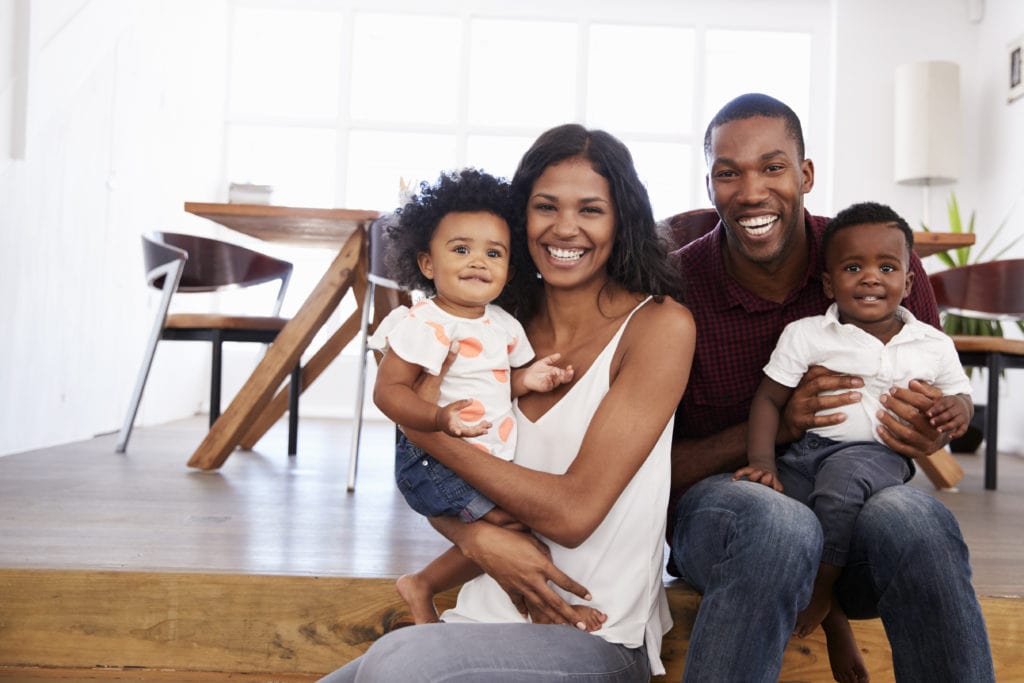 Portrait Of Family With Young Children At Home Together.