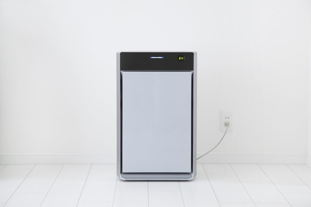 Air purifier in a white room centered in the middle.