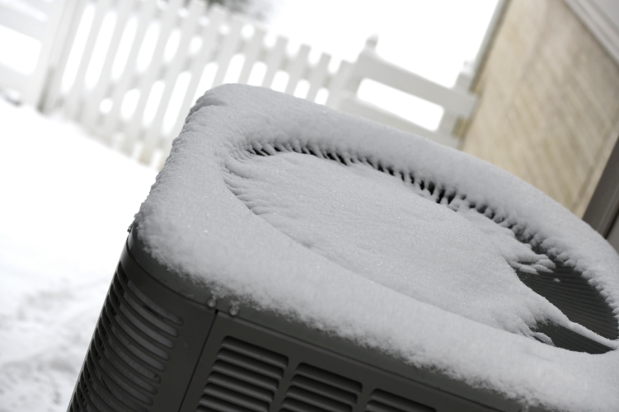 Fresh snow on top of a heat pump..