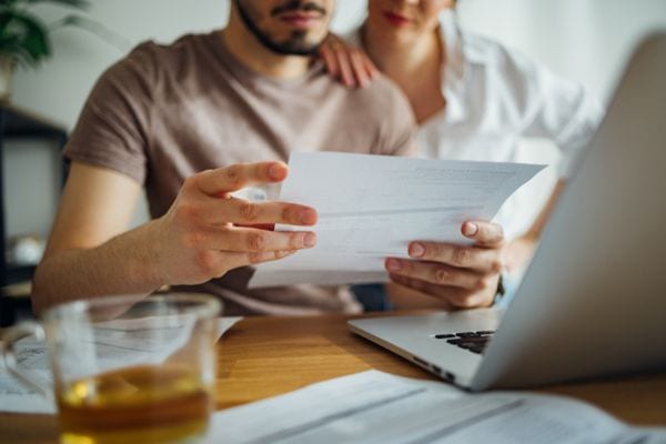 Image of couple going over paperwork. 5 Ways to Lower Your Energy Costs.