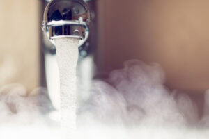 Bathtub water spout with hot water steam.