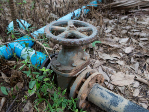 What to Do If Your Main Line Drain Is Clogged. The water valve on the pipe in farm.
