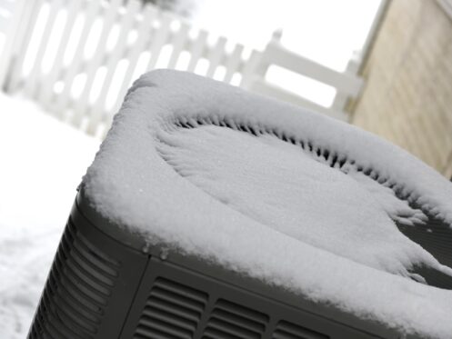 Fresh snow on top of a heat pump.